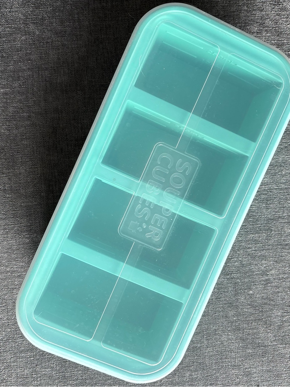 Genuine Souper Cubes® 1-Cup Silicone Freezer Tray in Aqua with clear lid.